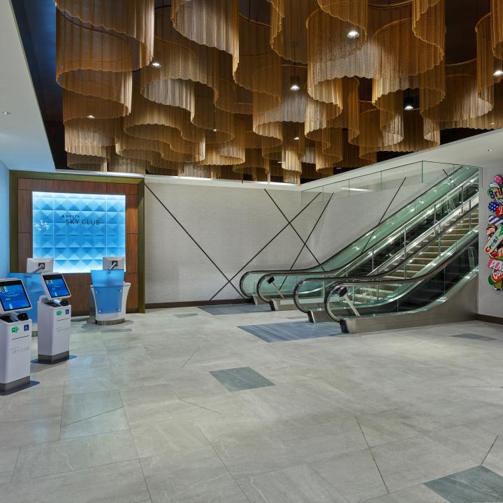 Once checked in, guests will ascend the monumental staircase or escalators, passing beneath dazzling ceiling fixtures modeled after ocean waves before arriving at the custom wood-screened area that marks the Club’s entrance. 