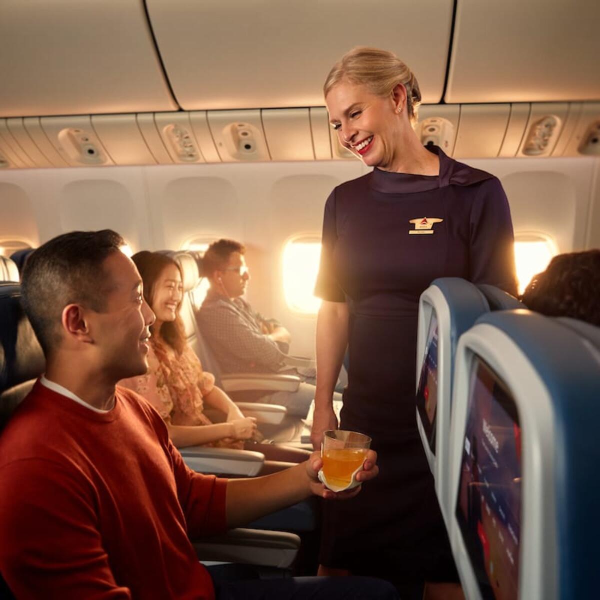 Delta flight attendant tends to a customer
