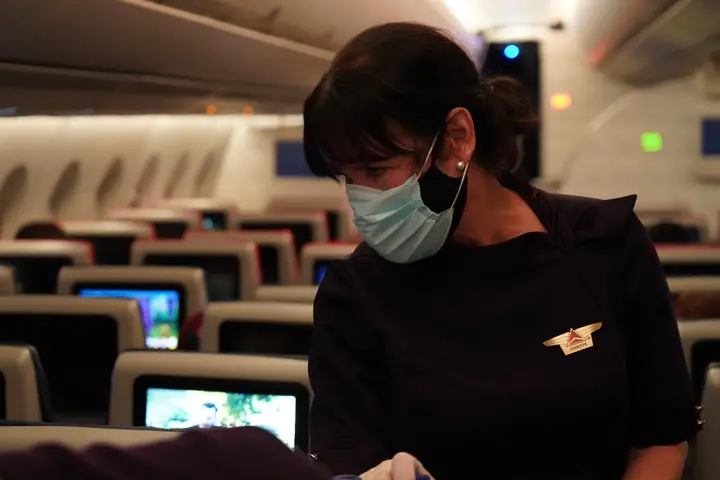 Delta Air Lines Flight Attendant serves passengers during CRAF mission.