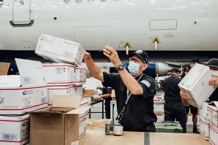 TechOps employee and veteran ships out 7,000th care package to military