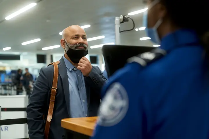A man passes through security using facial recognition technology.