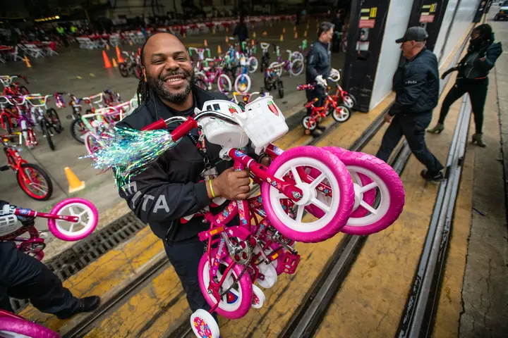 Members of Delta's TechOps work to assemble bikes for Toys for Tots.