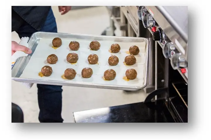 Photograph of Impossible Meatballs — a mix of Impossible Burger and Impossible™ Sausage and seasoned with a savory homestyle blend.