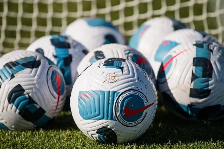 Arrary of soccer balls announcing partnership with National Women’s Soccer League 