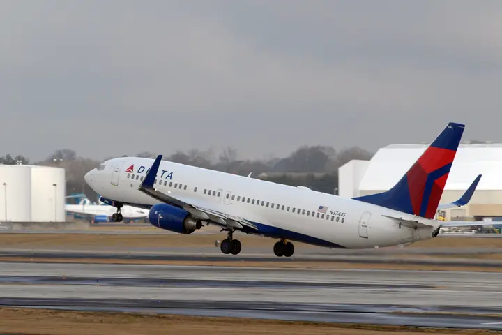 A 737-800 taking off into a gray sky.