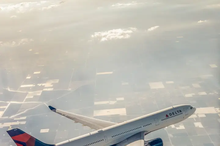 A330-300 in flight over city