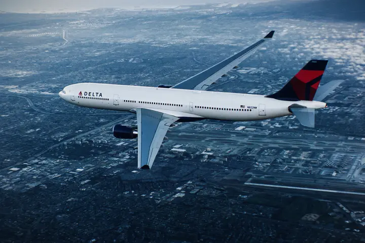 A330-300 in flight over city