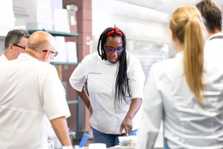 Chef Masama Bailey, whose signature Southern flair is now featured on Delta flights departing Atlanta, works with her team in the kitchen.