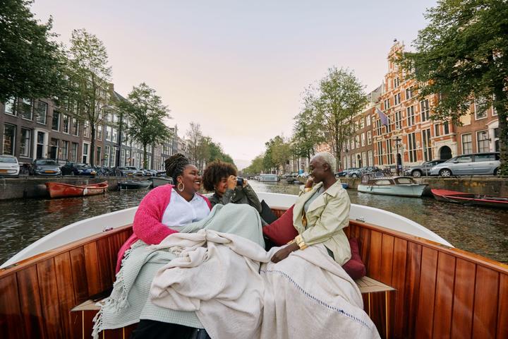 Three women sitting in a boat.