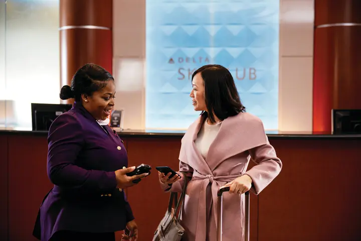 A customer checking in to a Delta Sky Club
