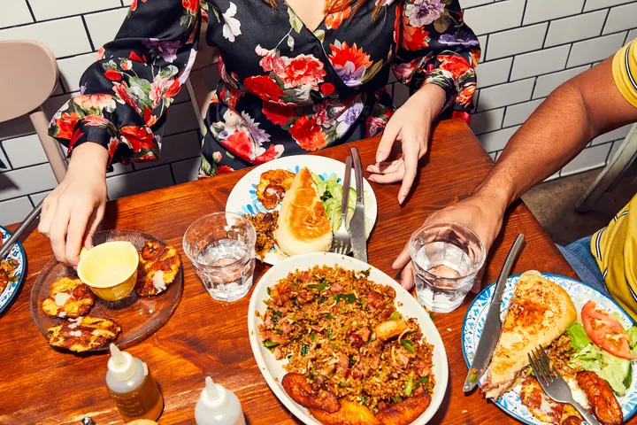 People dine at a table.