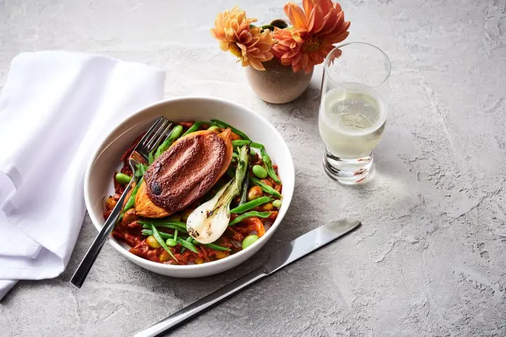 A bowl of roasted sweet potato tagine with chermoula sauce