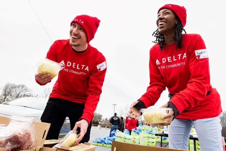 Two Delta employees volunteer at Hosea Helps in Atlanta during the annual "Hosea Helps Festival of Services" event.