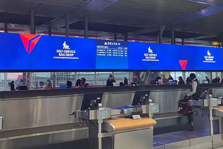 Delta's updated bag drop area at its newly consolidated Terminal 4 in New York City - JFK utilizes the latest technology to improve efficiency during busy travel times.