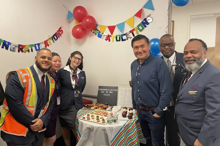 Todd O. celebrates achieving 14 Million Miler Status with Delta people at John F. Kennedy International Airport (JFK).