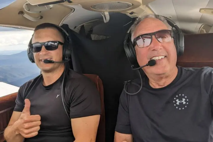 Delta pilots Barry Behnfeldt and Aaron Wilson sit in the cockpit of a six-seat 1980 PA32R Piper Saratoga.