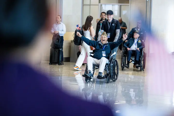 WWII veterans are greeted at the Hartsfield-Jackson Atlanta International Airport before boarding a flight to Normandy, France for the 79th annual commemoration of the 1944 D-Day invasion.  