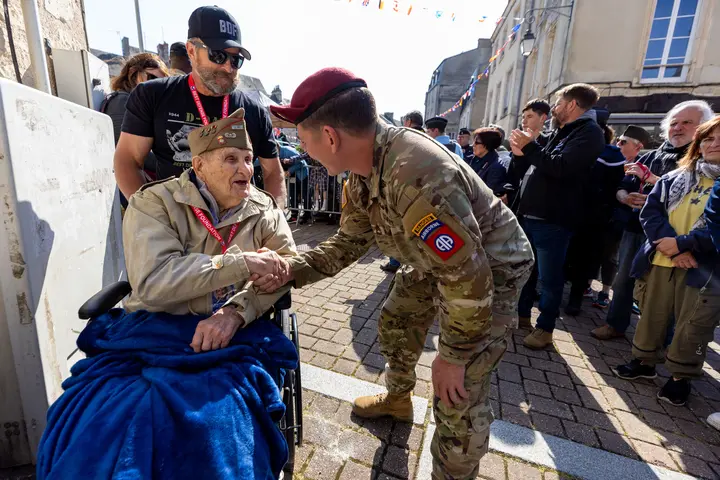 A World War II veteran is greeted by an Army Ranger in Normandy in June 2023.