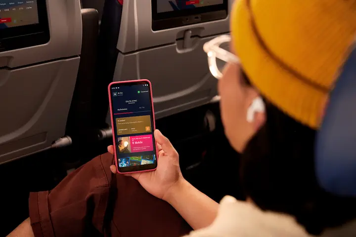 Delta customer browses Delta Sync using Delta's free Wi-Fi.