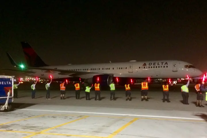 Delta employees usher in the first flight to Delta's new home at LAX during the airline's large terminal move that began in 2017.