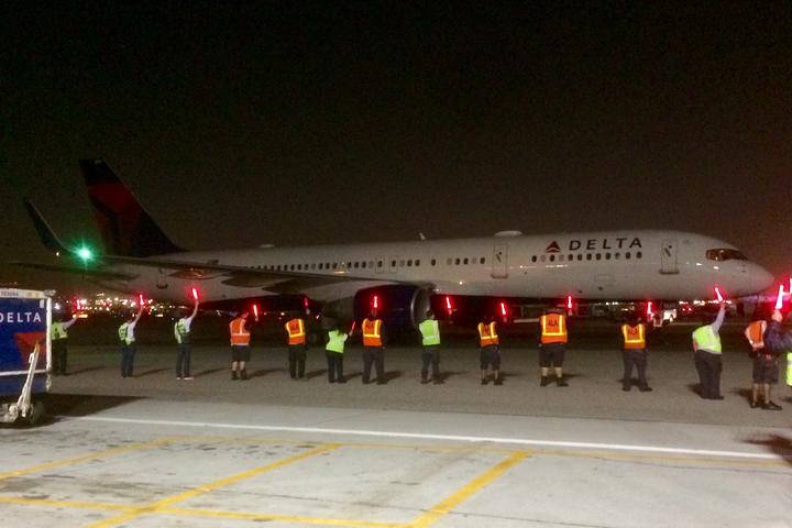 Delta employees usher in the first flight to Delta's new home at LAX during the airline's large terminal move that began in 2017.