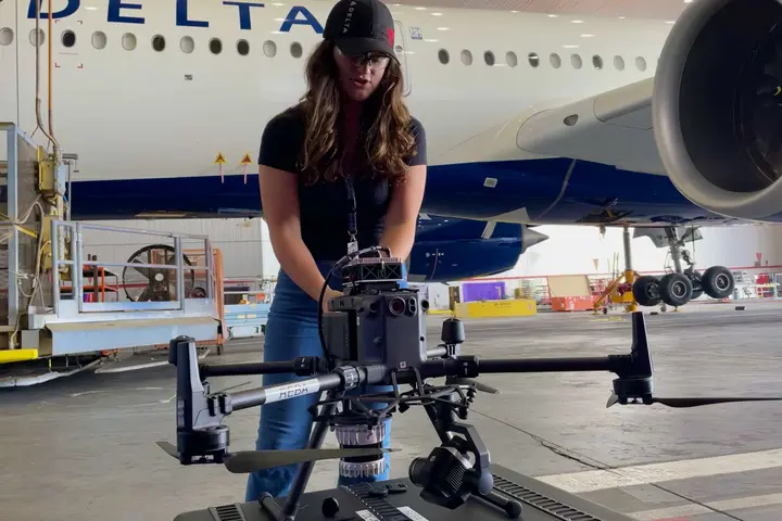 Emma Galarza, a senior engineer with Delta TechOps, prepares an autonomous drone for flight.