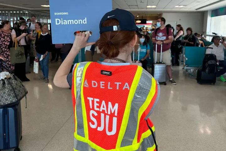 A child holds up a boarding sign at San Juan Airport as part of a special initiative to inspire excitement about aviation. 