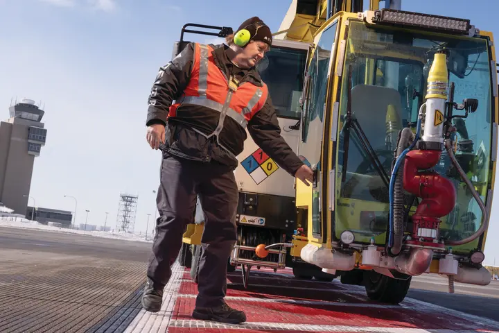 Ramp Agent Bruce Torseth prepares to de-ice aircraft at Minneapolis-St. Paul International Airport.