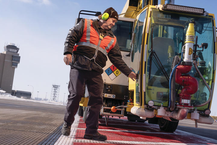Ramp Agent Bruce Torseth prepares to de-ice aircraft at Minneapolis-St. Paul International Airport.
