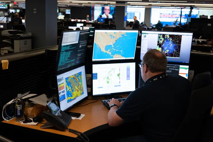 Warren Weston, a member of Delta's in-house meteorology team, sits as his desk in the Operations and Customer Center in Atlanta.