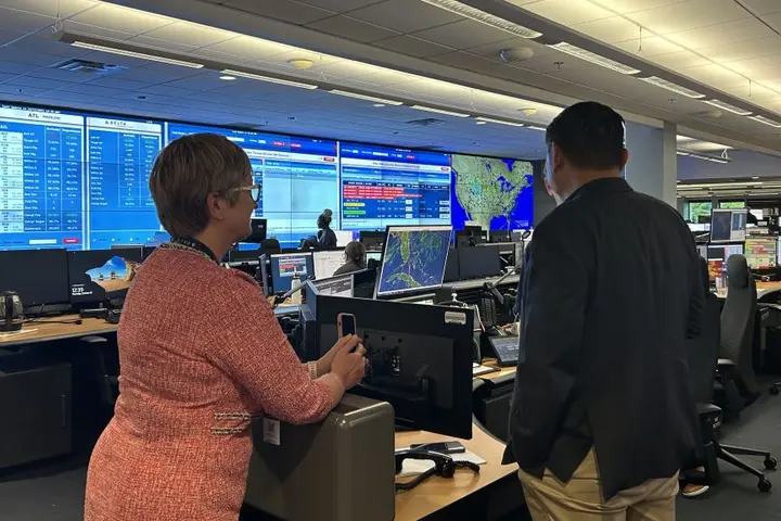 A Delta employee shows Todd O., Delta's most frequent flyer, around the OCC, the heartbeat of the operation with constant flight, emergency and weather tracking. 