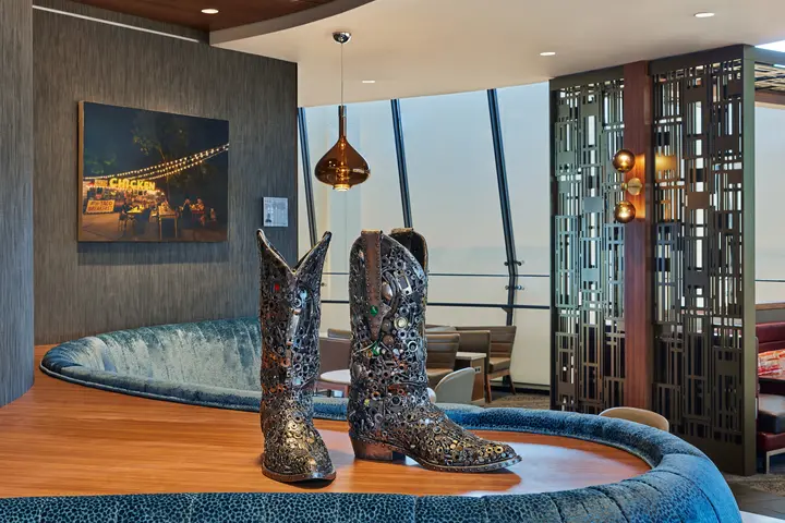 A pewter rhinestone cowboy boot sculpture sits in the Delta Sky Club in Austin, Texas.