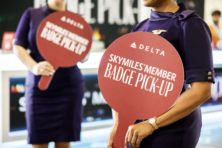 Austin-based flight attendants and Red Coats assist in assisting guests with a dedicated badge pick-up area for SkyMiles Members at the Austin Convention Center Rotunda Foyer during SXSW 2024.