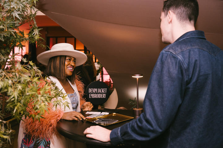 A SkyMiles member checks into the Denim Jacket Embroidery Station at Delta's SXSW lounge.&nbsp;