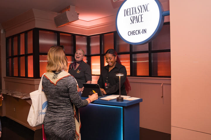 A Delta Lounge goer checks in to the Delta Sync space, a dedicated experience that provided quieter moments for members to focus and immerse themselves in locally curated content.&nbsp;