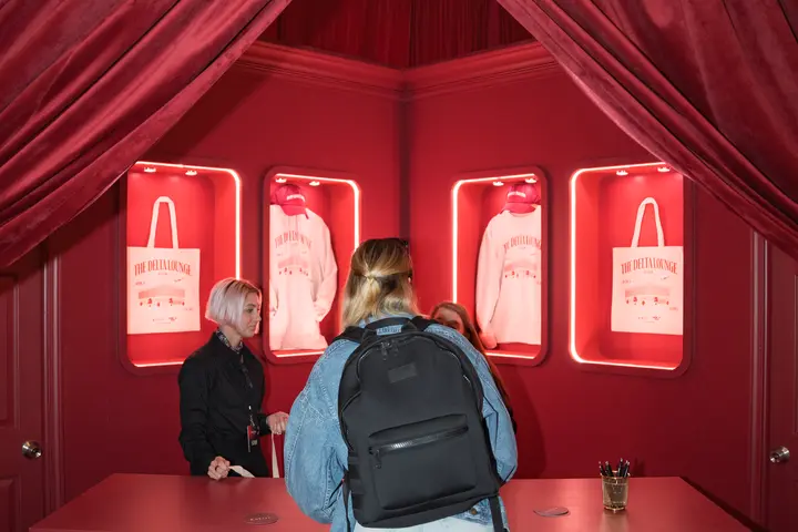 A SkyMiles member stops by the Gifting Salon in the Delta Lounge, an exclusive merch station where lounge goers were given a ticket to redeem custom limited-edition Delta x SXSW merchandise such as hats, tote bags and sweatshirts.
