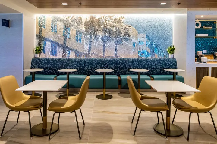 A new mosaic pays homage to the city’s classic Art Deco architecture, while the overall color palette reflects the nearby turquoise waters, blue sky, and white and gold accents seen in south Florida designs. 
