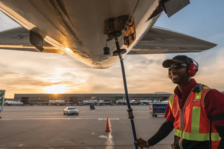 Ramp agent working under an aircraft