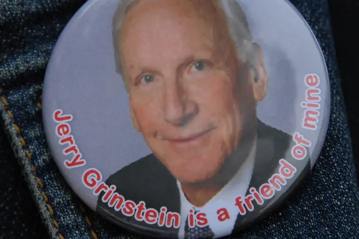 A button featuring former Delta CEO Jerry Grinstein that reads "Jerry Grinstein is a friend of mine."