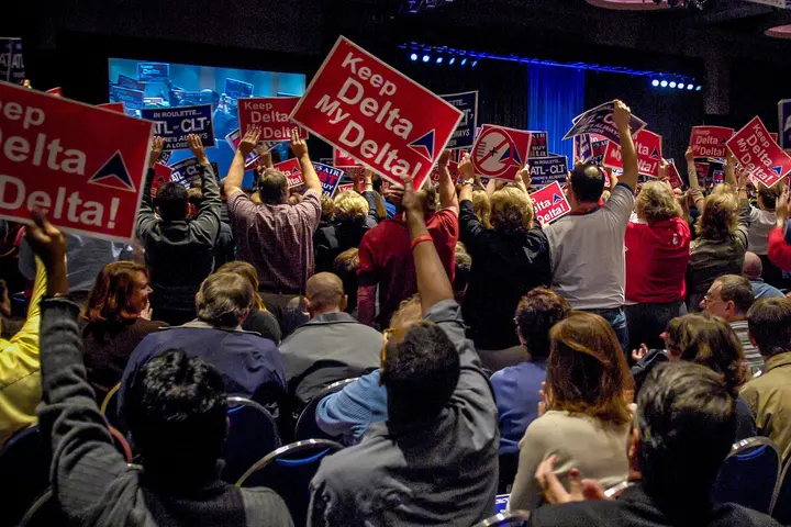 Delta employees and other hold up "Keep Delta My Delta" signs in support of the airline in 2006.