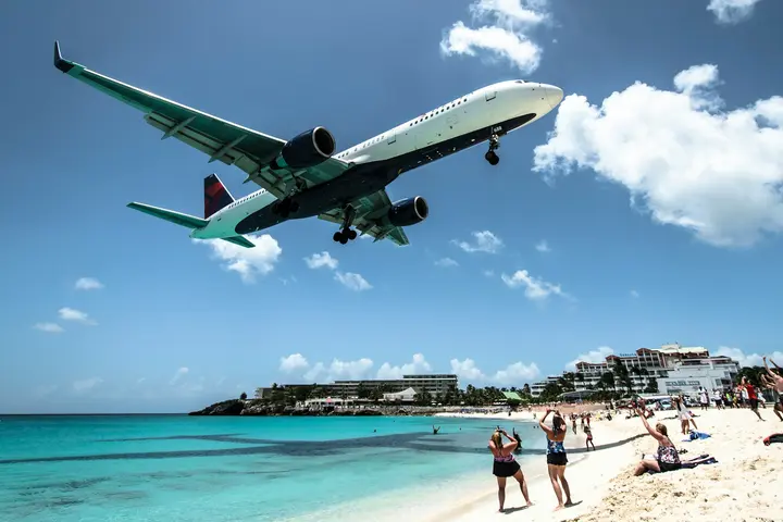 A Delta plane flies over Maho Beach in St. Maarten.