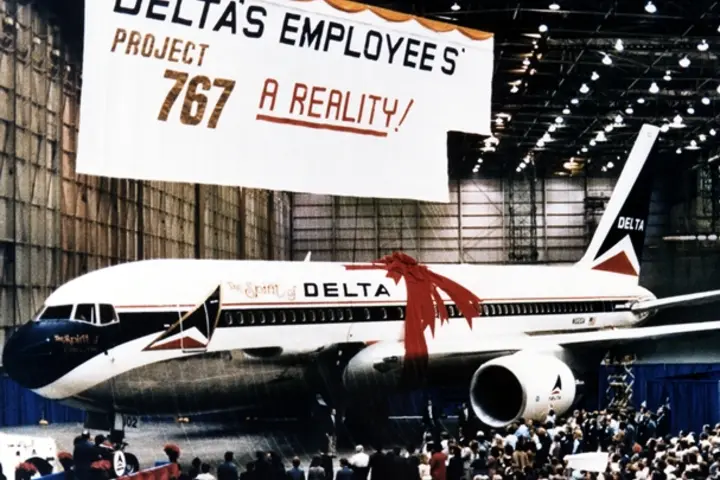 The Spirit of Delta plane sits below a large "Project 767" banner.