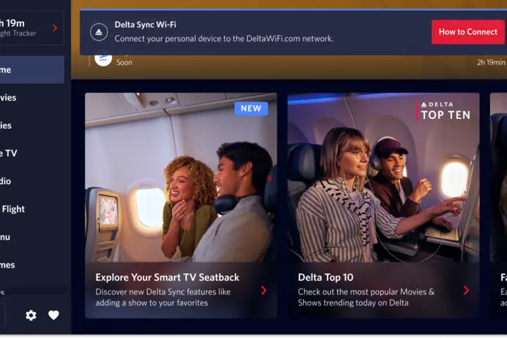 A seatback screen shows a notification informing passengers that fast, free Wi-Fi is available for their personal devices. 