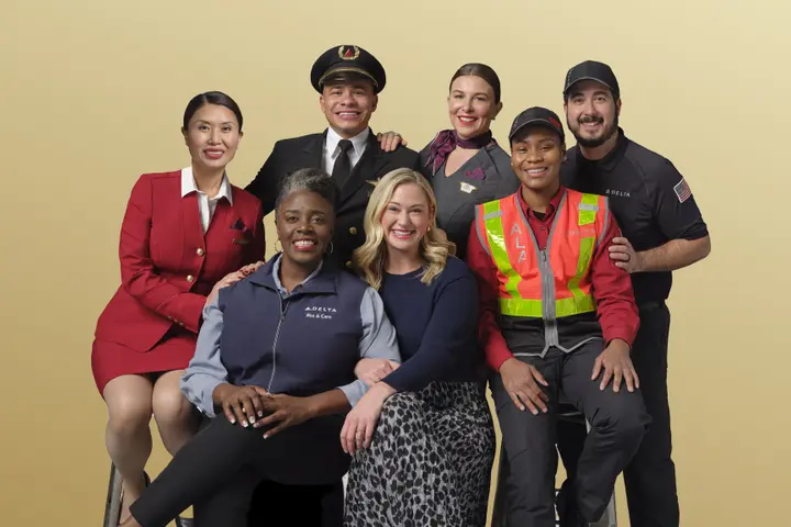 Delta people from across the airline's business pose in this 2024 photo.