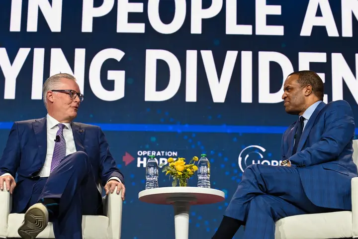 Delta CEO Ed Bastian (left) speaks at the HOPE Global Forum.
