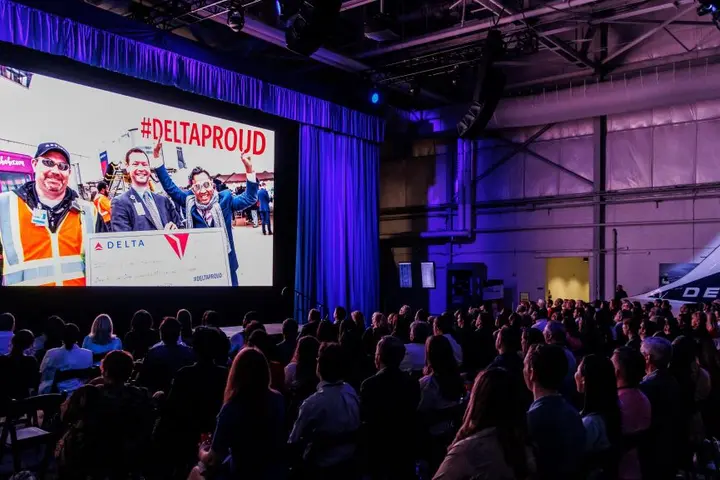 Delta employees watch the screening of Delta's documentary "The Steepest Climb."