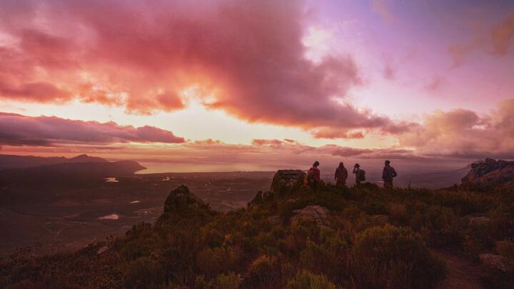 People on a mountaintop with a colorful sunset for Delta's new "Kaleidoscope" brand spot.