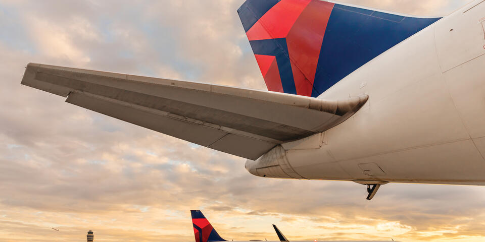 Overlooking an afternoon skyline near the Atlanta headquarters, Delta's Boeing 767-400 dorsal area features a wingspan of 171 feet and a tail height of over 50 inches.