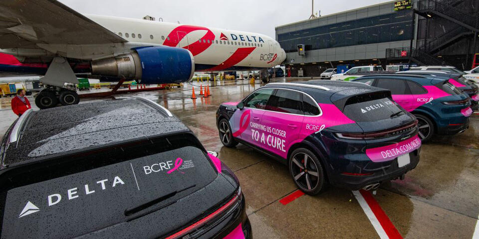 BCRF plane awaits takeoff amidst BCRF branded Porsches on September 26, 2024.