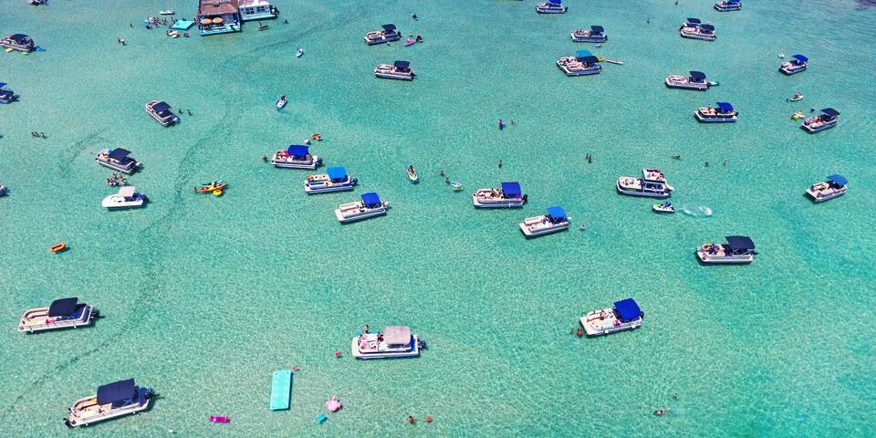 Aerial view of boats on crystal blue waters in Destin, Florida